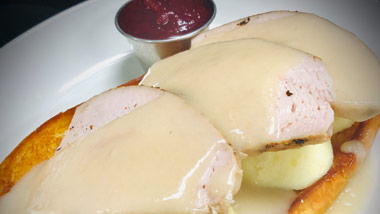 open faced turkey sandwich with gravy and cranberry sauce